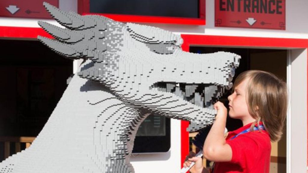 Stanley Bollard cleaning a Lego model of a dragon at Legoland Windsor