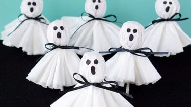 lollipops covered with a coffee filter with a ghost face drawn on