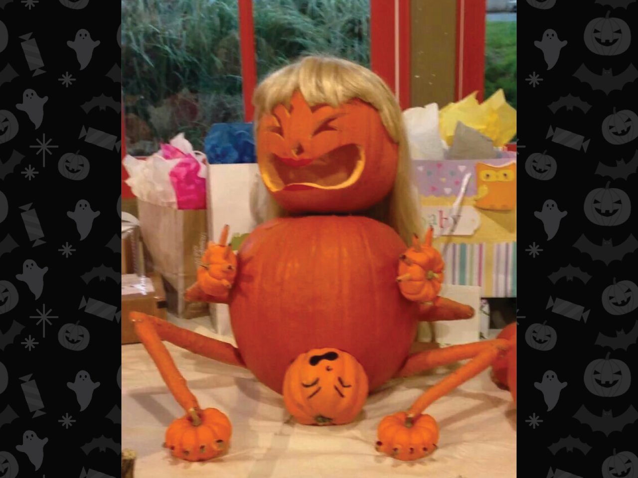 pumpkin carved as pregnant woman wearing a blonde wig and giving birth