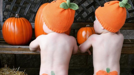 Babies wearing pumpkin hats