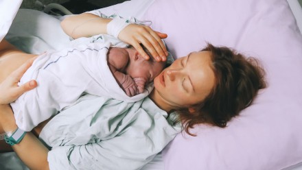 Mother holds her newborn baby in the hospital.