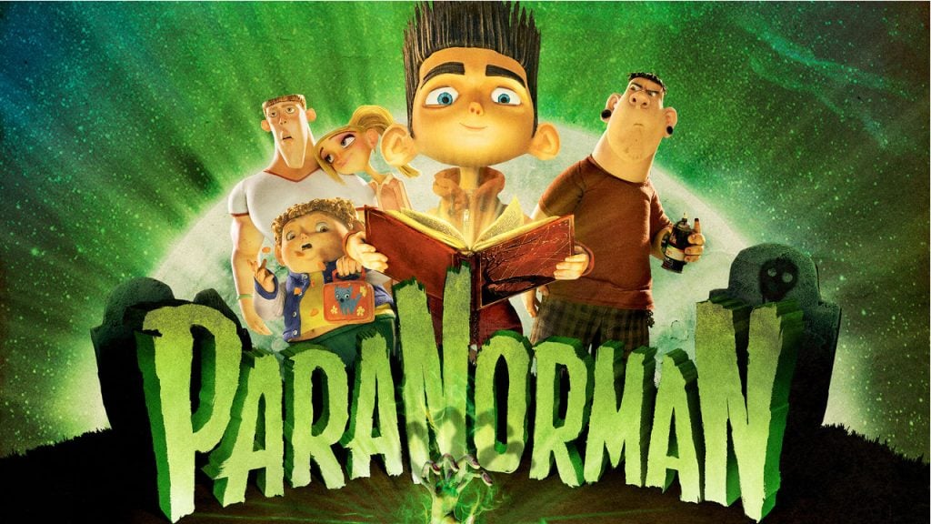 Promo image for the movie ParaNorman. shows an animated boy holding a book and smirking with his friends standing behind him