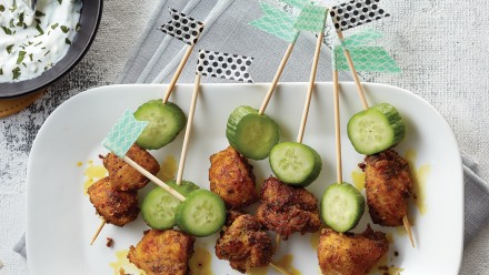 Wooden skewers with marinated chicken and cucumber
