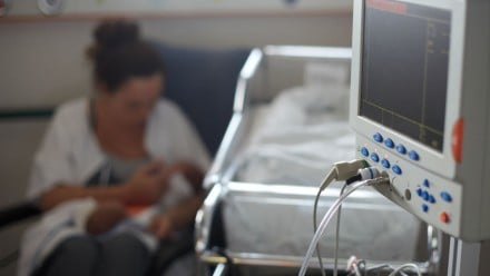 Mother holding her baby in the NICU