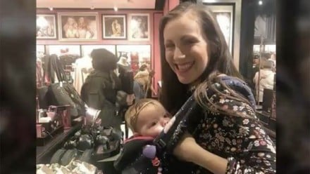 Woman breastfeeding her baby inside a Victoria's Secret store