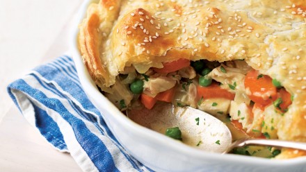 casserole dish with creamy chicken pot pie topped with a sesame seed studded crust