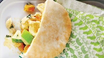 Half a pita filled with chunky chicken and apple salad