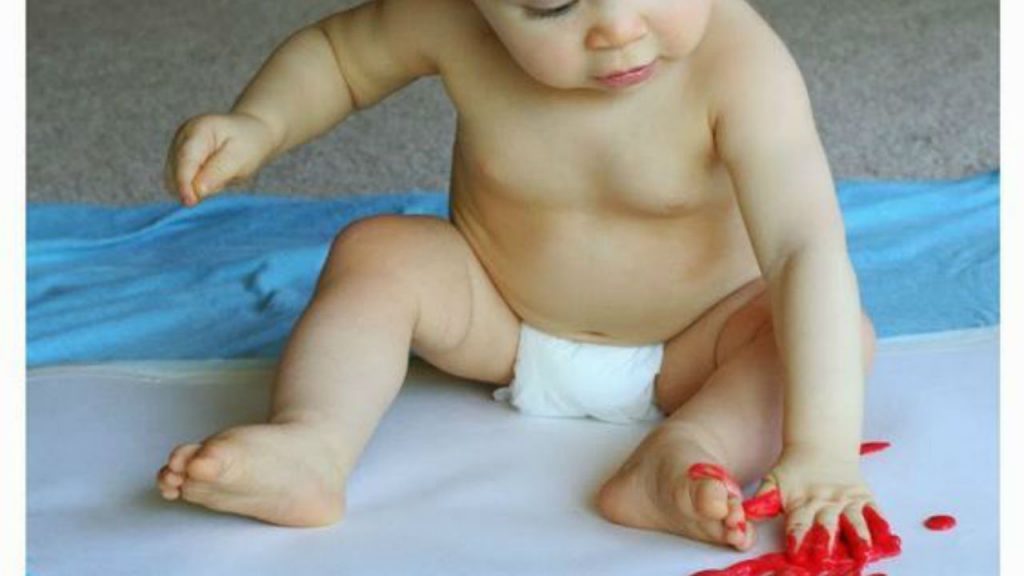 baby playing with edible paint