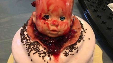 Bloody baby head coming out of a vagina baby shower cake