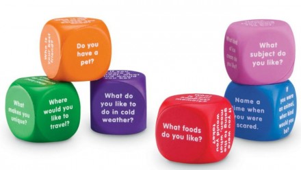Colourful cubes with personal questions like "Do you have a pet?" written in white.