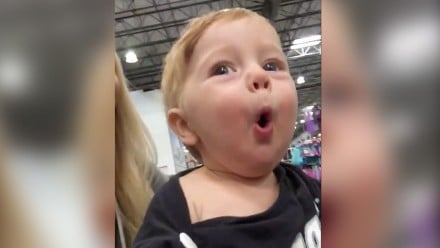 Baby boy in awe of Christmas decorations at the store