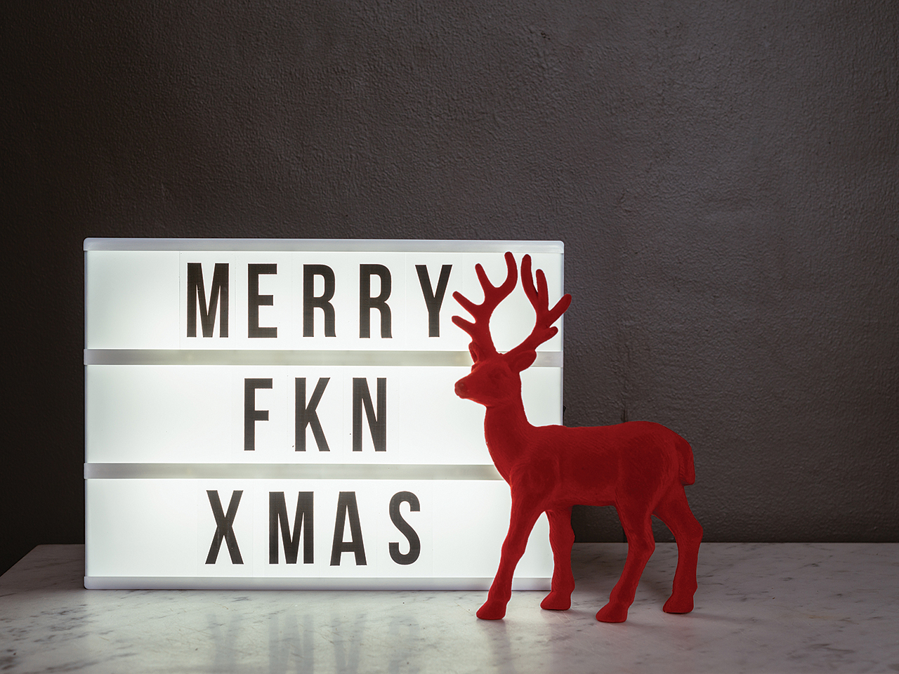 Lightbox with Merry Fkn Christmas message and red deer