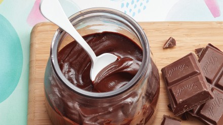 Glass jar with thick chocolate sauce inside