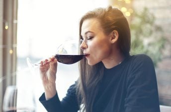 woman drinking a glass of red wine