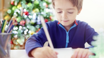 child writing Christmas thank-you cards