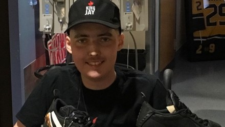 Jay holding his shoes in the hospital