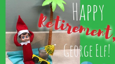 Image of an Elf on the Shelf doll laying under a palm tree with its hands behind it head. Image reads, "Happy Retirement, George Elf!"