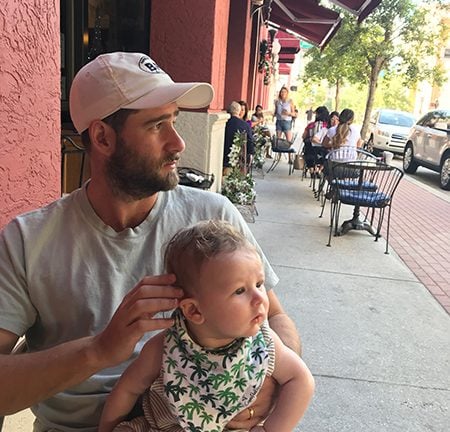 Whitney Port's husband sits with their baby