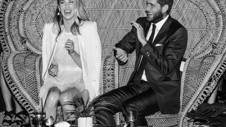 Whitney Port sits with her husband at the wedding reception