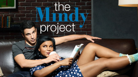 Promo Image for The Mindy Project showing a couple laying on a leather sofa