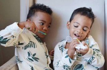 Two boys brushing their teeth