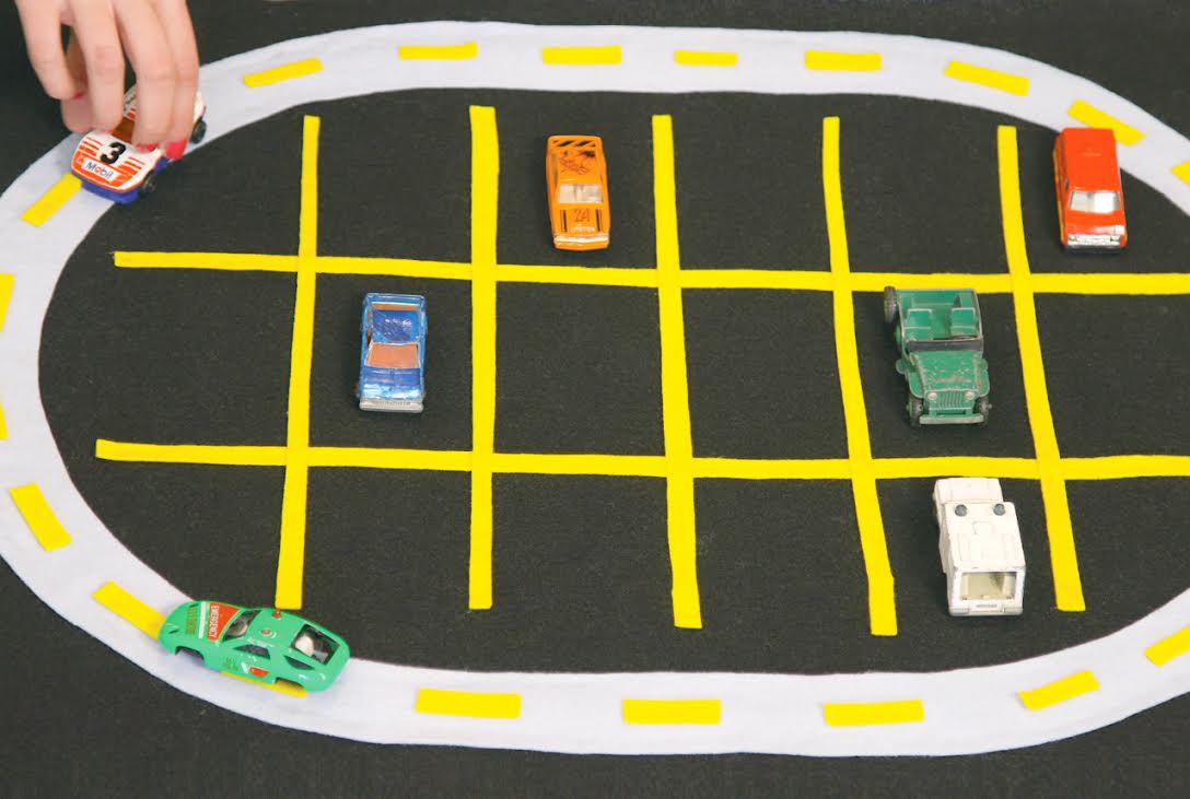felt mat with race track and parking spaces for dinky cars