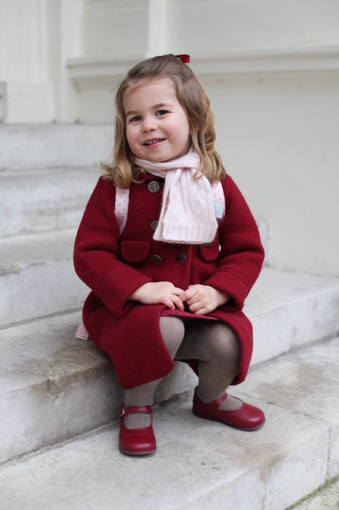 Princess Charlotte sitting on steps of Kensington Palace