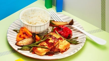 Plate with roasted tofu with glaze and roasted veggies with rice