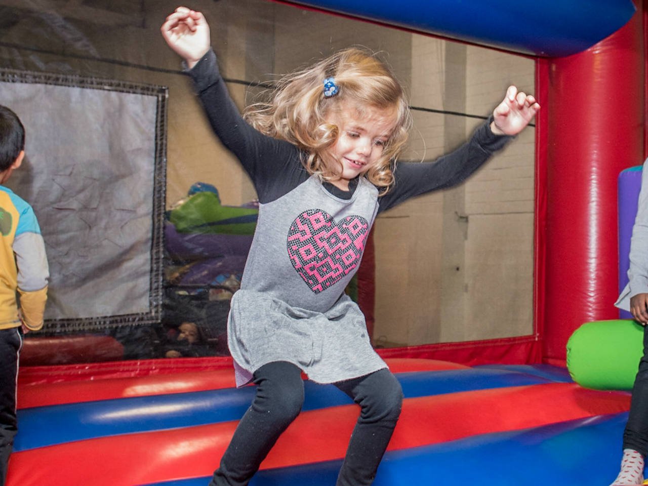 Little girl jumping in bounce house