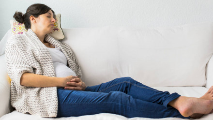 Pregnant woman resting on couch