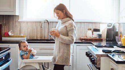 Mom and baby in the kitchen drinking milk