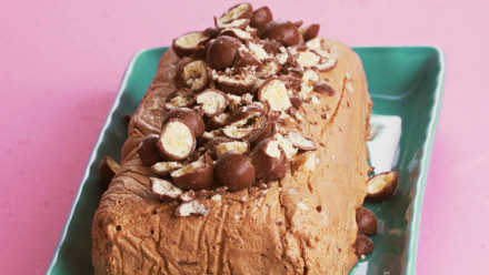 A chocolate ice cream cake with chocolate candy sprinkled on top