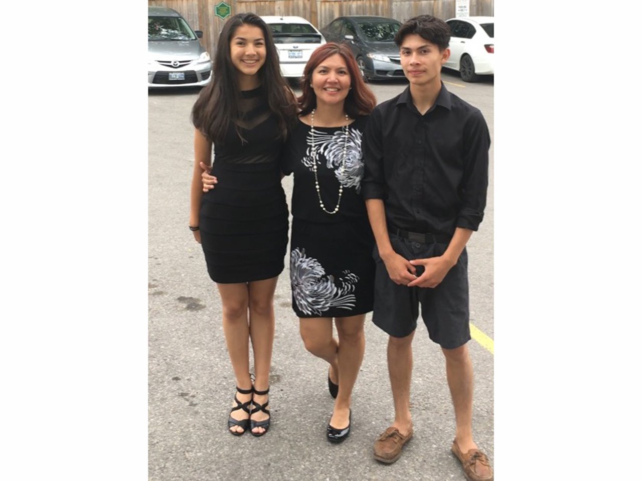 Photo of an indigenous mom and her teen daughter and son
