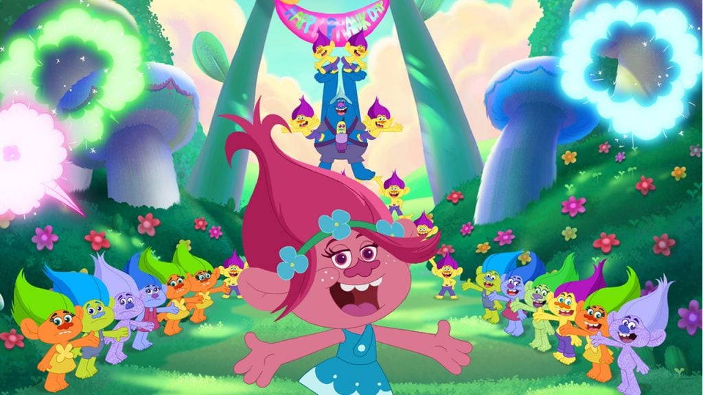 Promo image for Trolls the Beat Goes On showing Poppy singing a song with other trolls in a garden