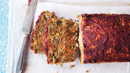 Lentil loaf bake cut into slices with a tomatoey crisped top