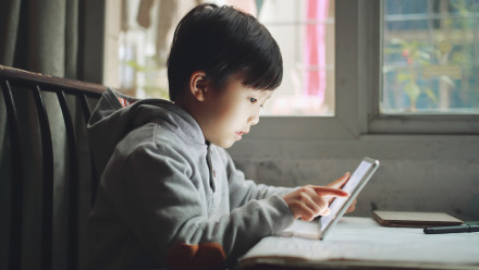 Young child playing on his iPad