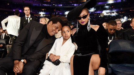 Blue Ivy, JayZ, and Beyonce sitting at the Grammys.
