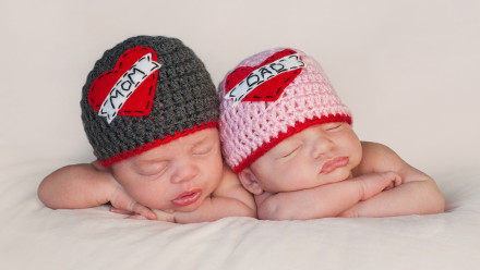 Twin babies wearing knit caps