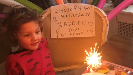 Photo of Hadrien Trudeau about to blow out his birthday sparkler on his fourth birthday