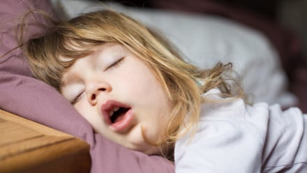 Little girl sleeping with her mouth wide open