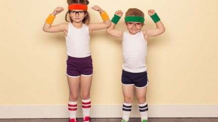 Two kids flexing in old school workout gear