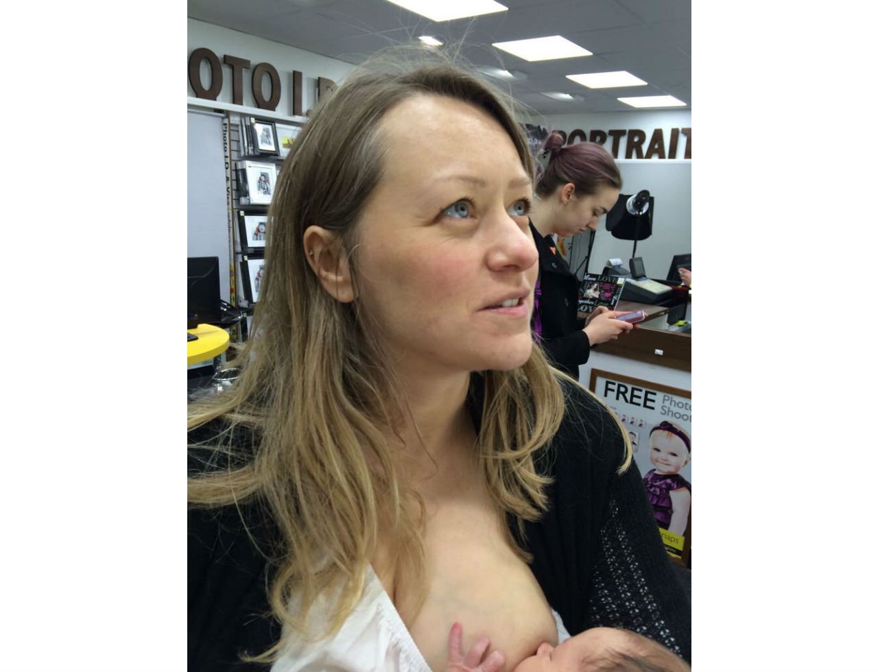 Mother breastfeeding her baby in public