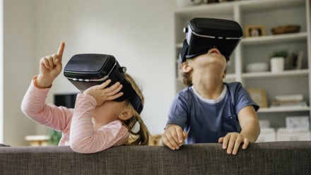 Two kids playing with VR glasses