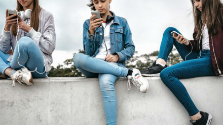 Girls sitting with smartphone