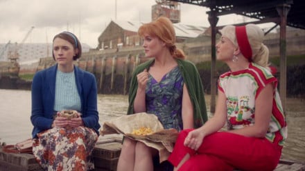 Promo image for Call the Midwife showing three ladies eating lunch under a bridge