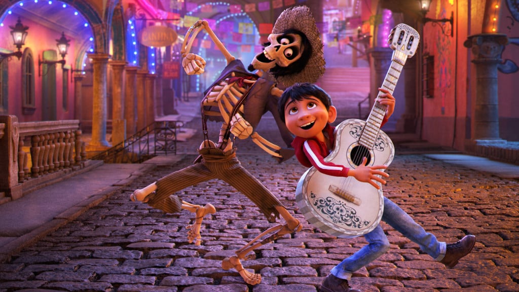 Image from the Disney movie Coco of a little boy with a guitar and a skeleton