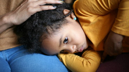 a mom comforting stomach pain in children