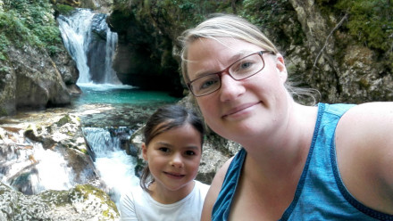 Mother and daughter by a waterfall.