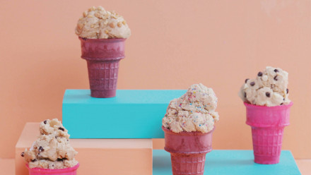Pink and purple ice cream cones with cookie dough in them