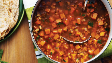 Pot of vegetable soup with barley, sweet potato and lentil